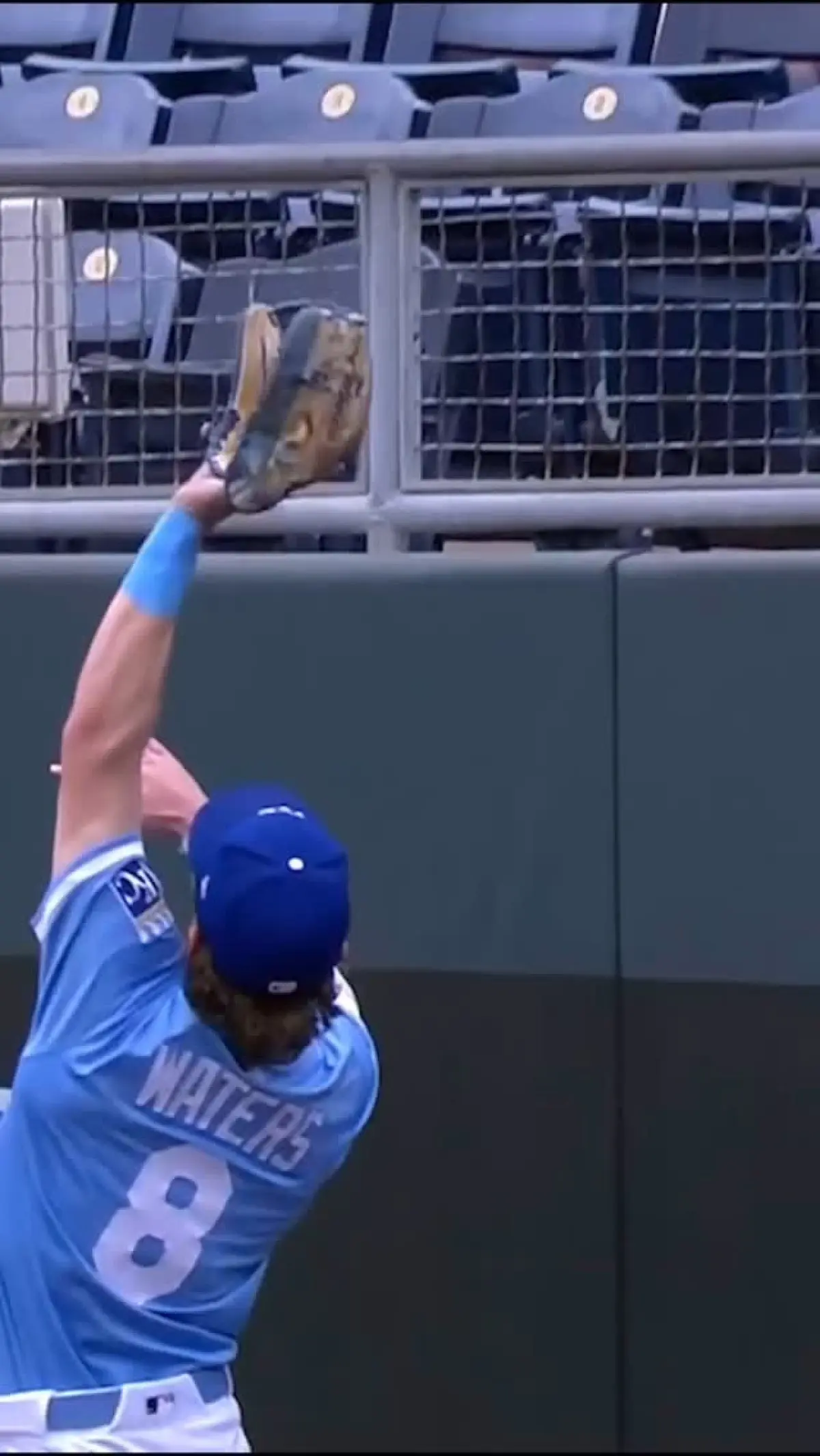 The outfielder's impressive leap highlights KC's strong defensive play.